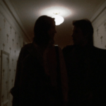 Mean Streets (1973) | Martin Scorsese production design | Martin Scorsese Films | Two silhouettes walking down white hallway with crucifix wallpaper