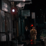 Mean Streets (1973) | Martin Scorsese production design | Martin Scorsese Films | Robert DeNiro and Harvey Keitel on the streets of New York with large gun sign as foreshadowing
