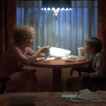 Alice Doesn't Live Here Anymore (1974) | Martin Scorsese production design | Martin Scorsese Films | Ellen Burstyn and son at table eating dinner in front of window in their hotel room